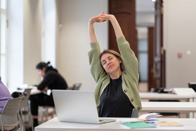 Woman Stretching In Office