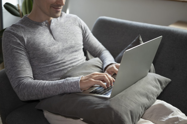 Man In Casual Clothes Laptop On Couch
