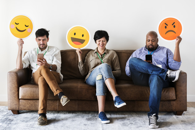 Diverse People Sitting And Holding Emojis